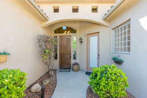 View of exterior entry with stucco siding