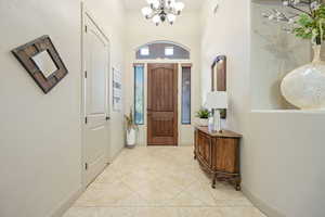 Foyer featuring hanging lights and light tile patterned flooring