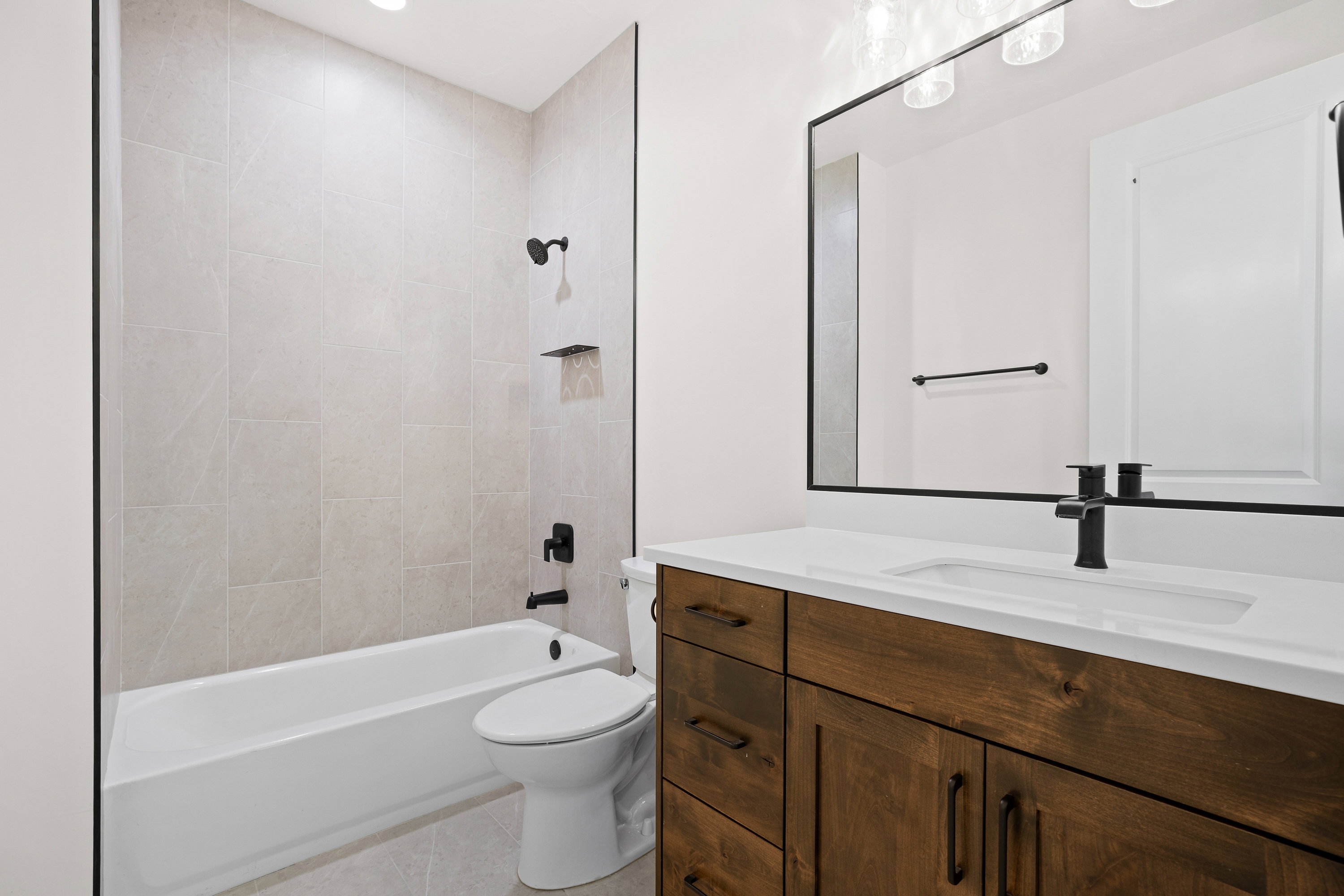 Bathroom featuring vanity, shower / bathtub combination, light tile patterned floors, and recessed lighting