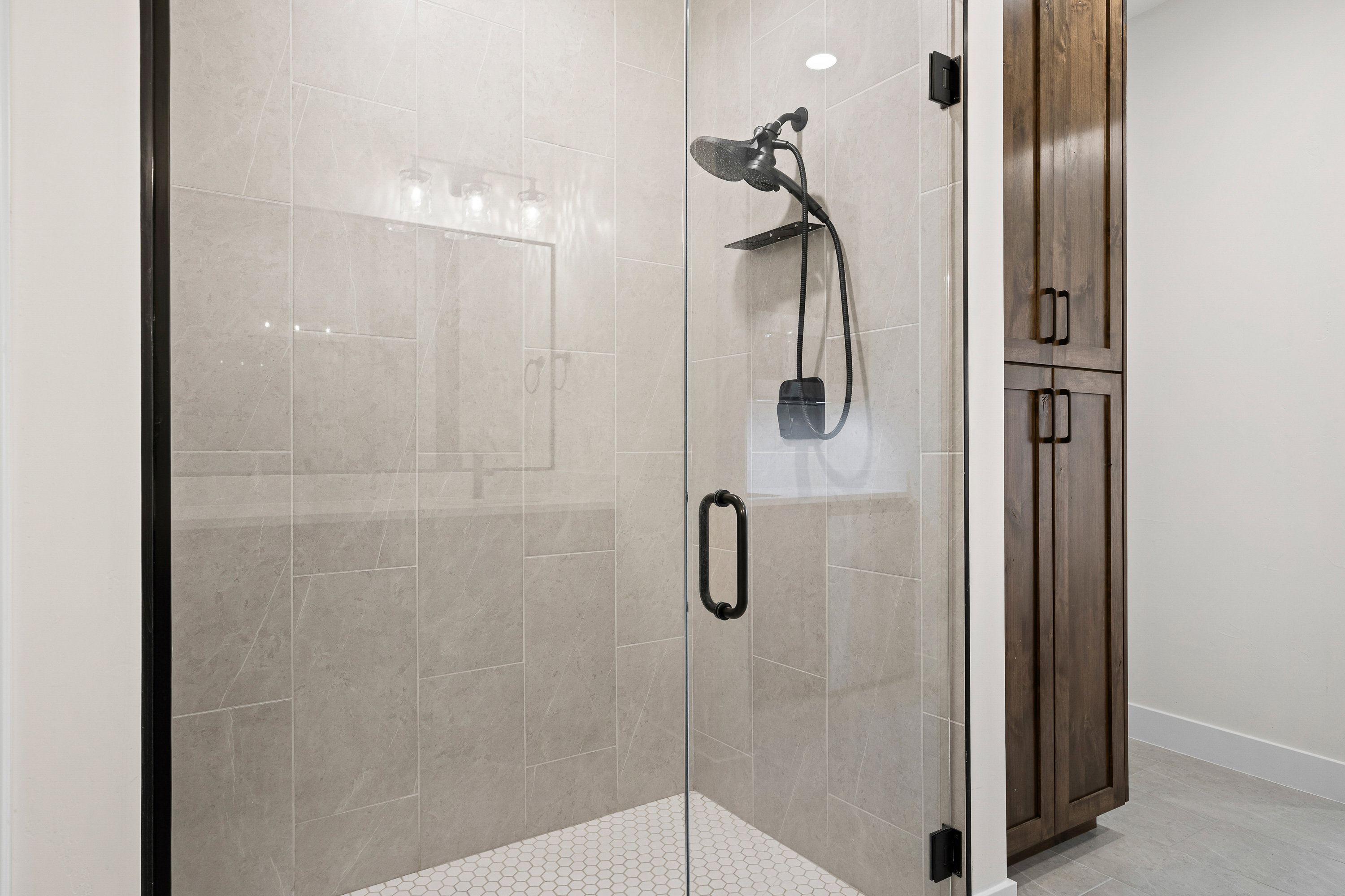 Full bathroom featuring a stall shower and baseboards
