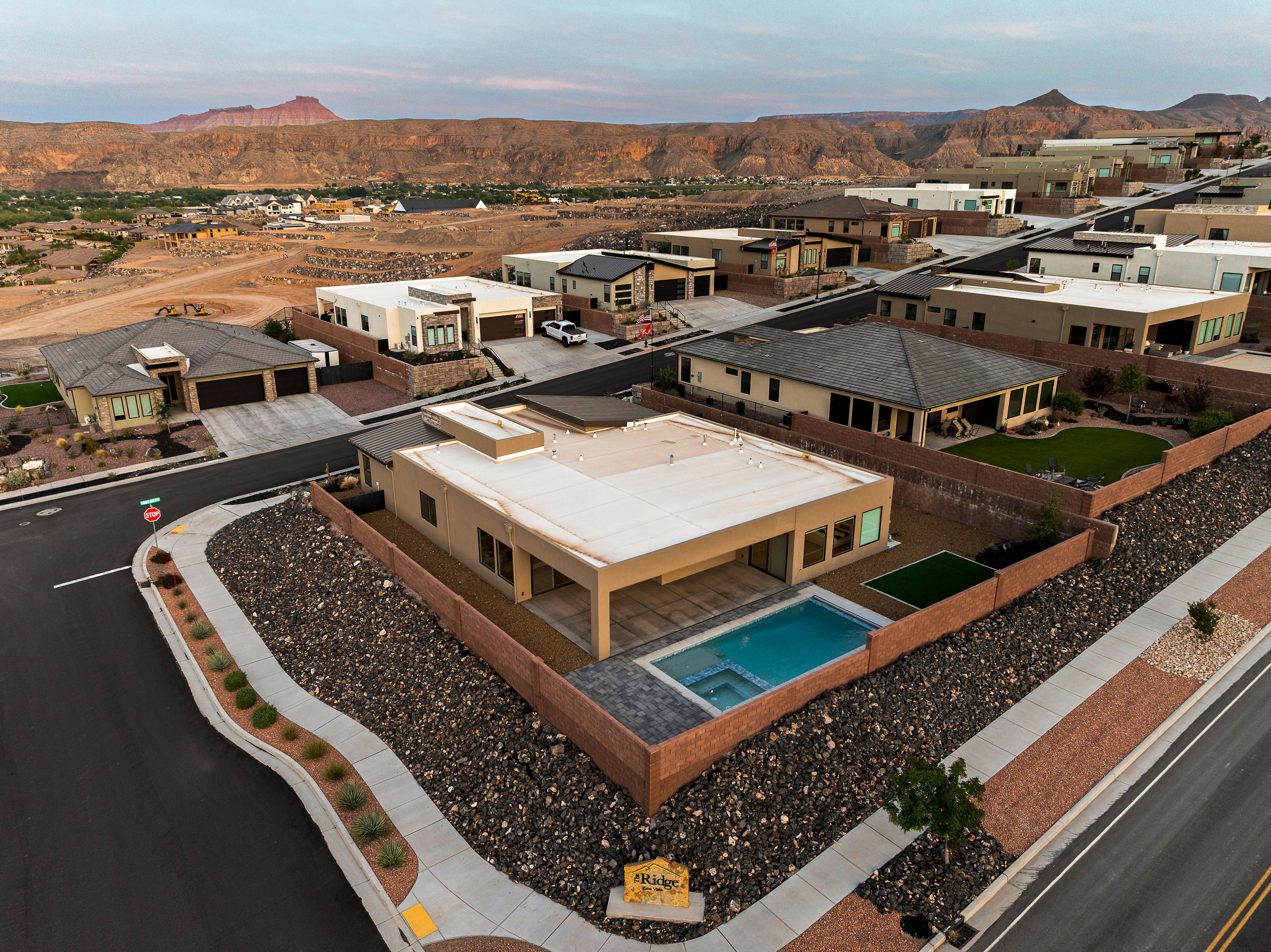 Aerial perspective of suburban area with a mountainous background