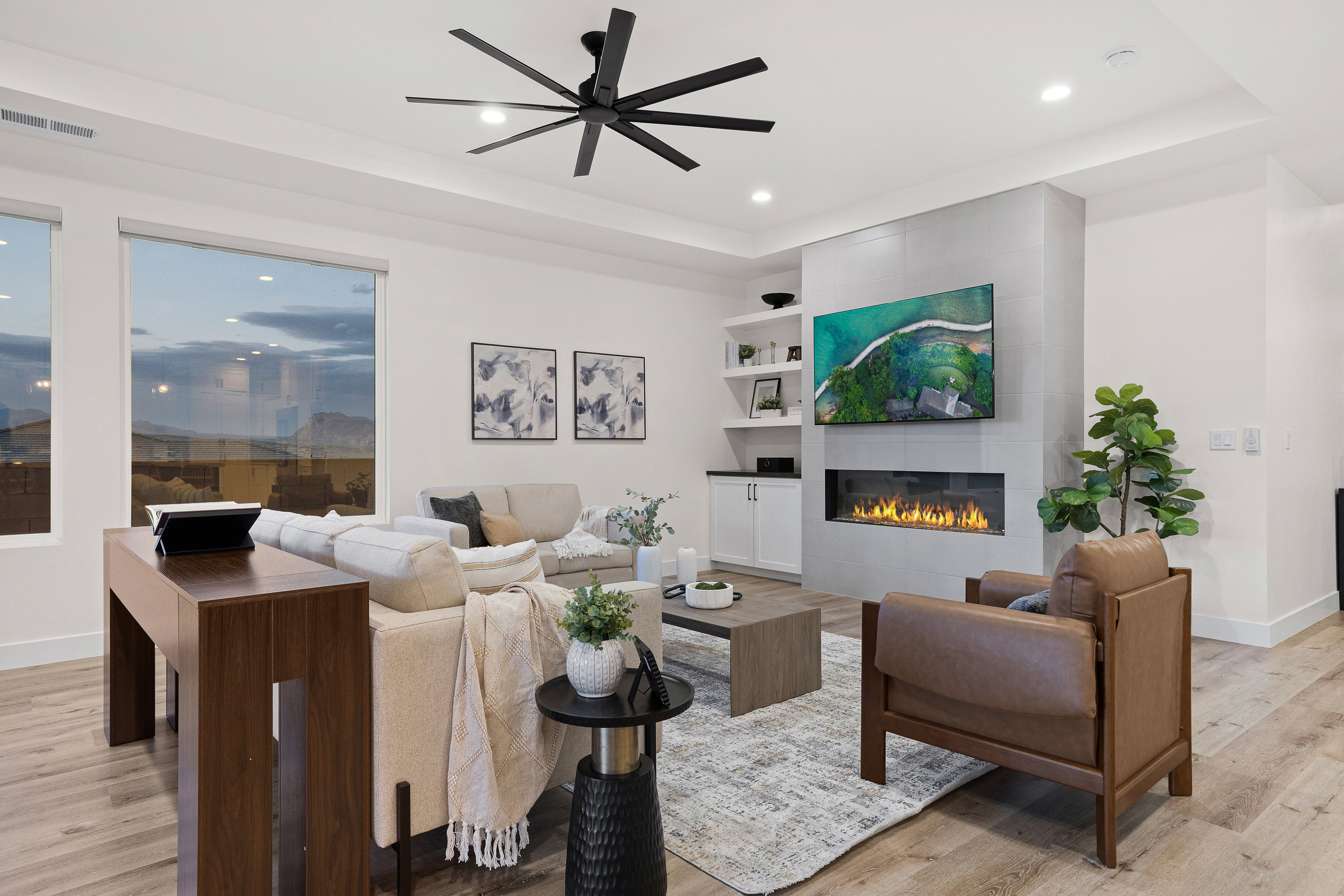 Living room with ceiling fan, light wood-type flooring, a tiled fireplace, built in features, and recessed lighting