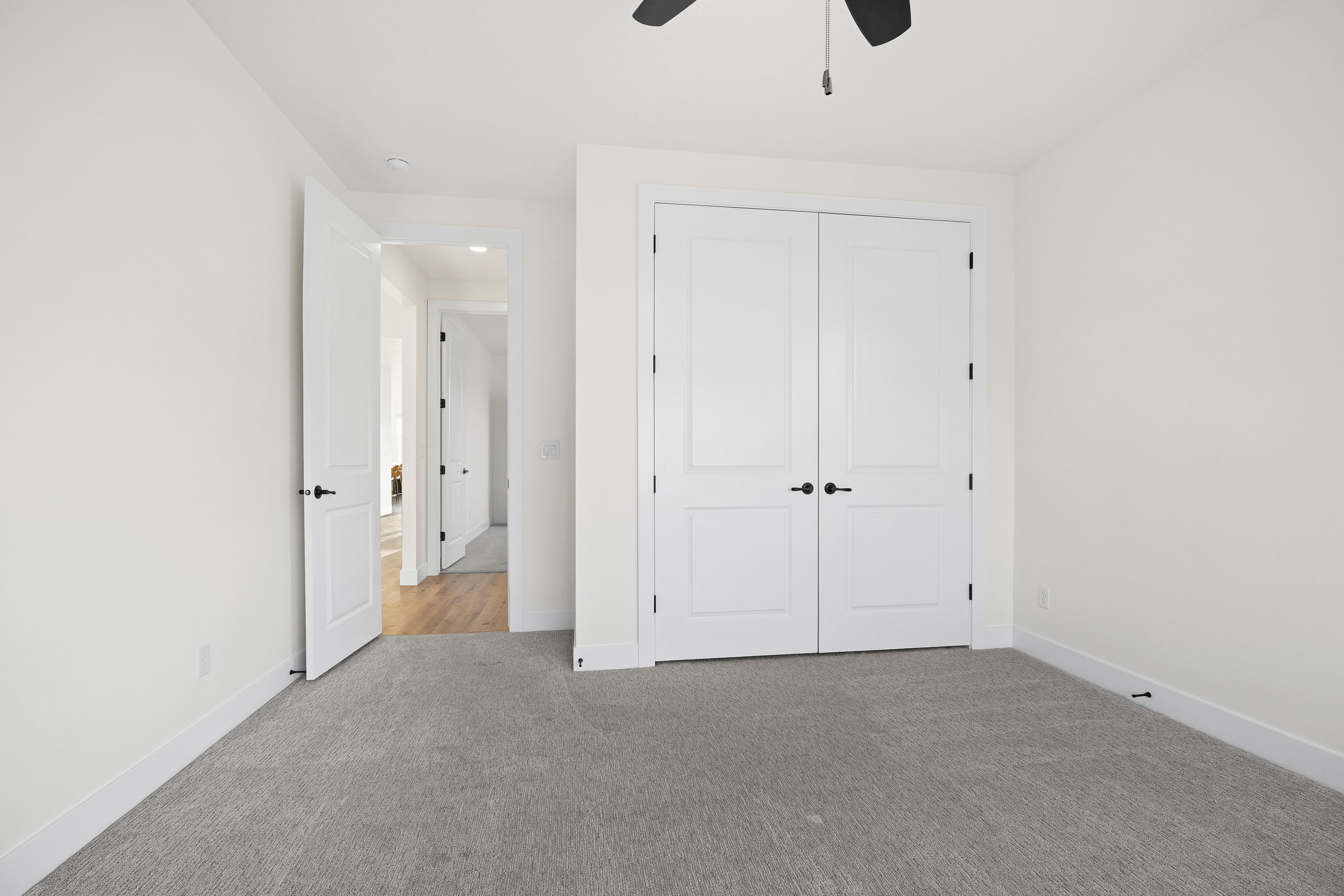 Unfurnished bedroom with carpet floors, a ceiling fan, and a closet