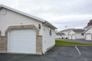 View of 1 Car Garage and Designated Parking Space