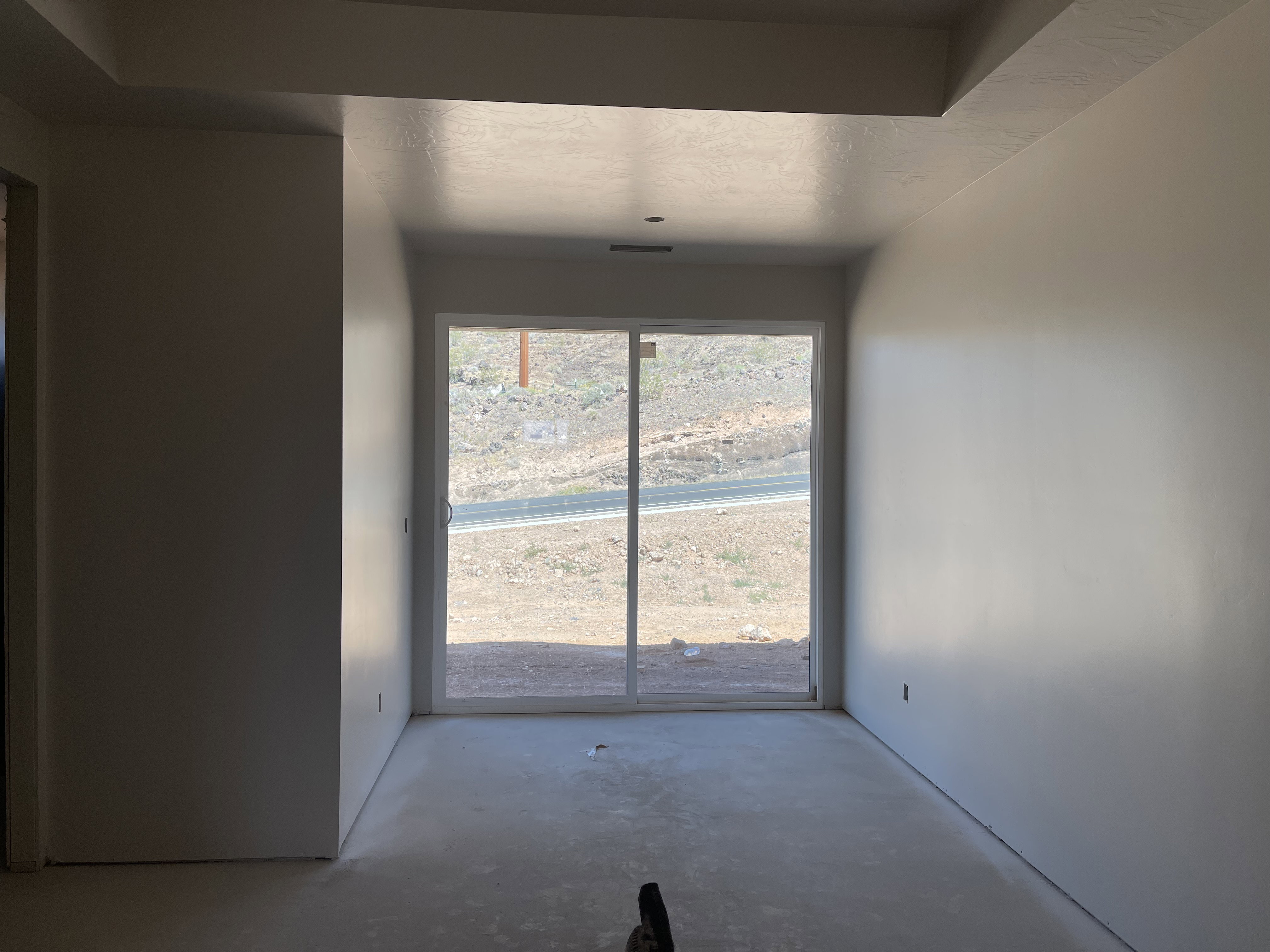 Empty room featuring unfinished concrete floors