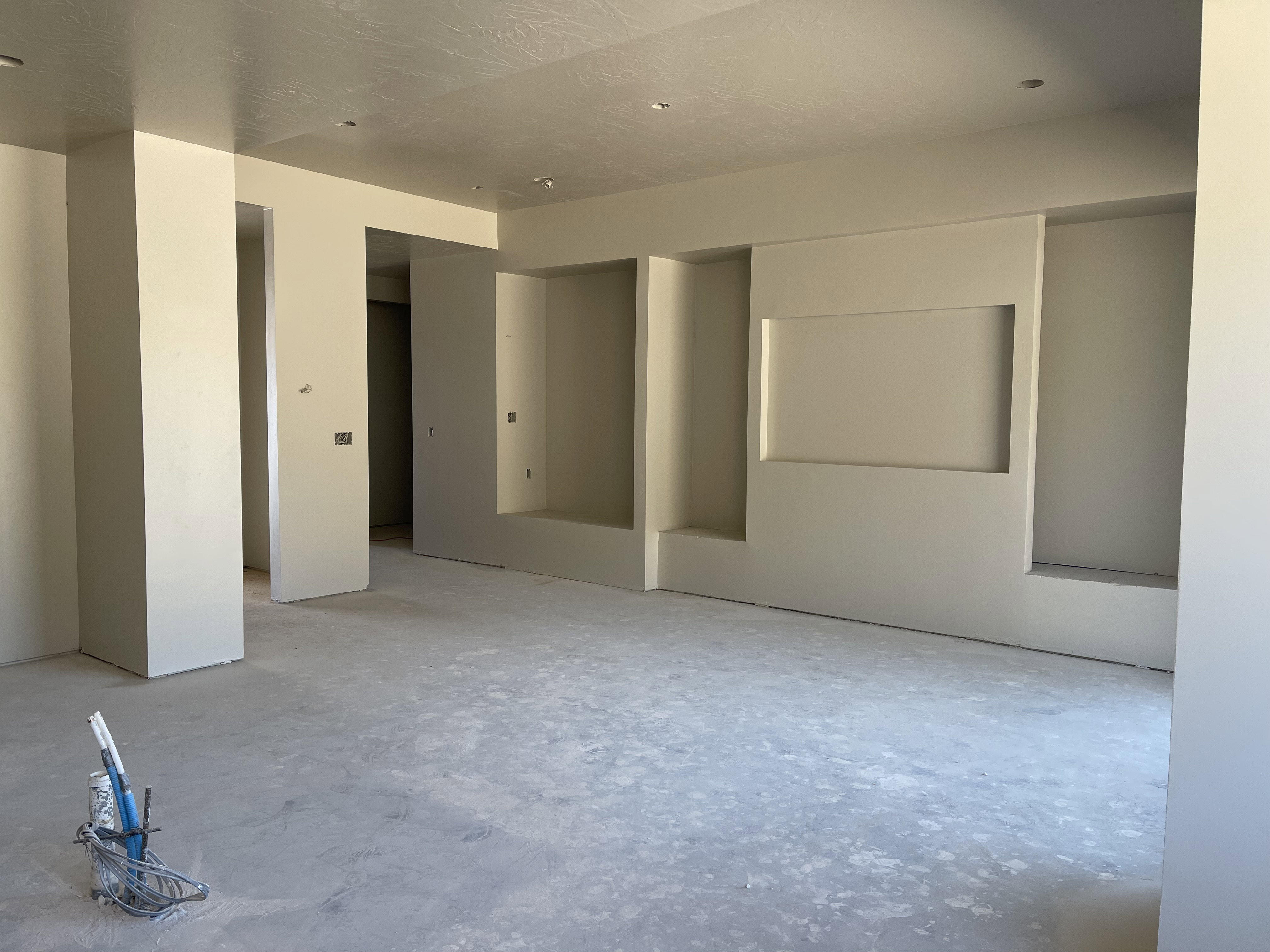 Unfurnished room with unfinished concrete flooring