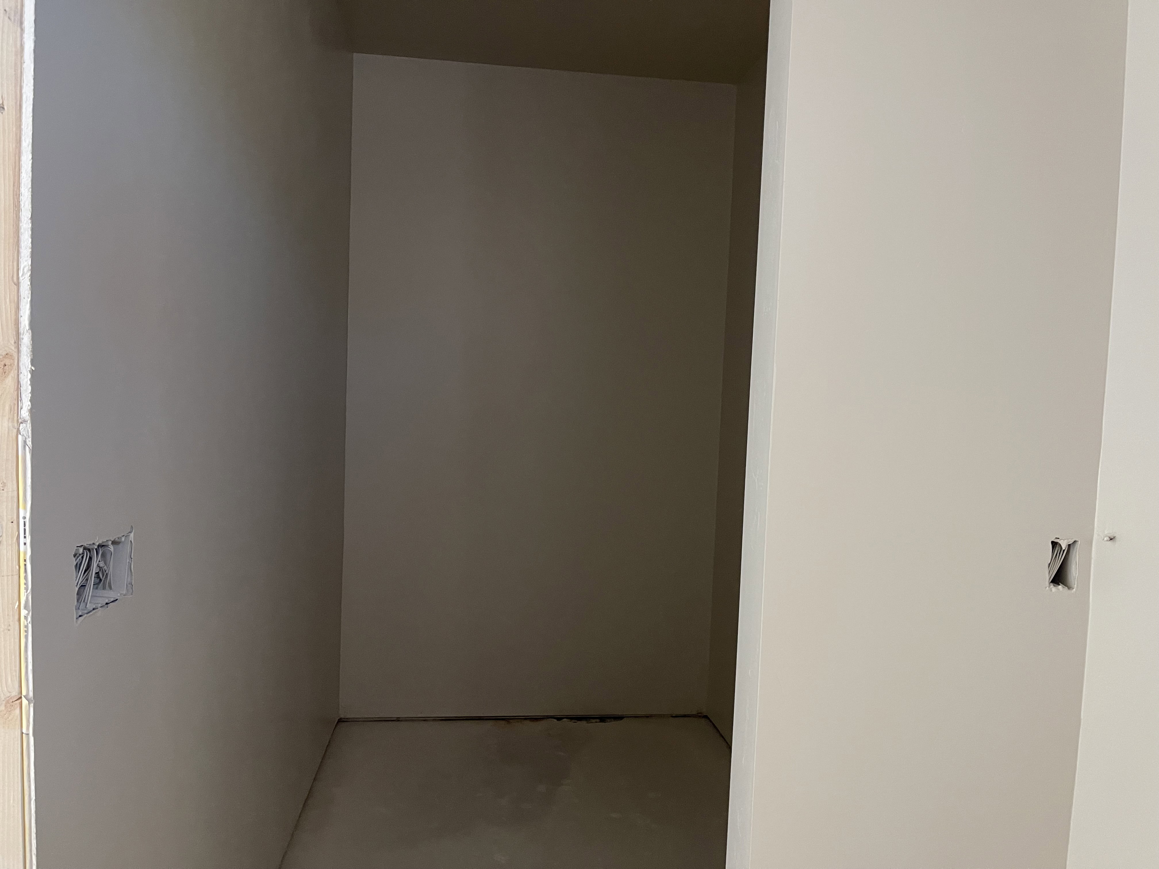 Hall featuring elevator and concrete flooring