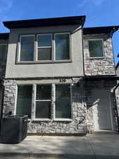 View of front of property with stone siding and stucco siding