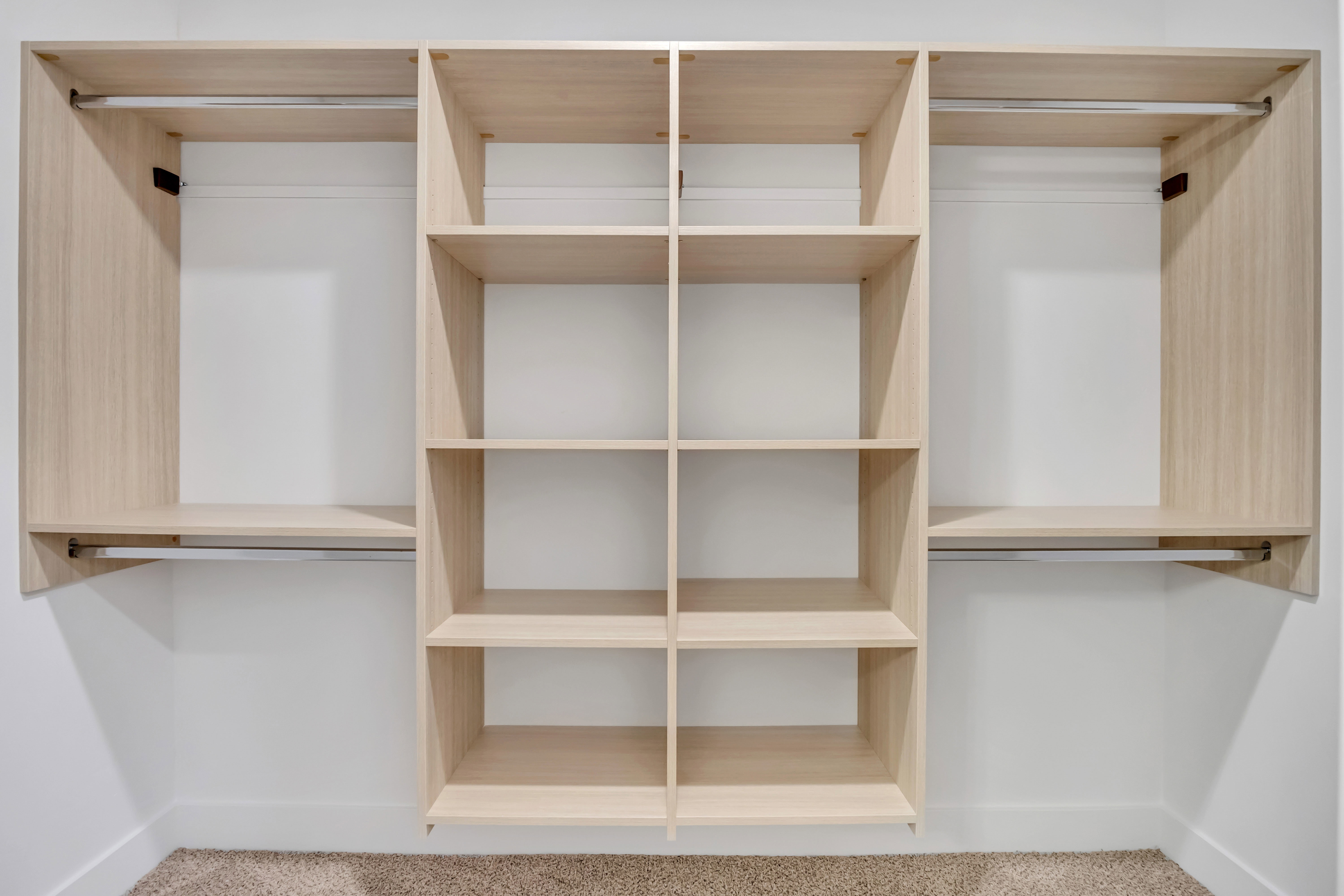 Built-in closet system featuring wood-finish shelving and hanging rods