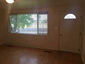 Foyer entrance with wood-type flooring and baseboards