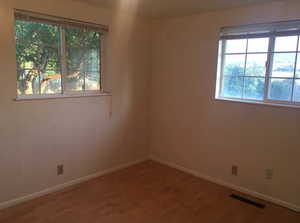 Empty room with light wood-type flooring and baseboards