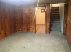 Finished below grade area with wooden walls and carpet