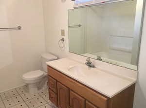 Bathroom featuring vanity and toilet shower / tub