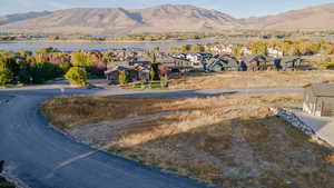 View of mountain backdrop featuring nearby suburban area and a nearby body of water