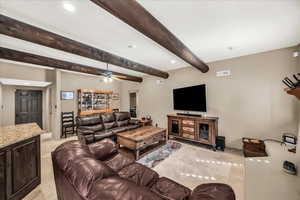 Living area with recessed lighting, beam ceiling, and ceiling fan