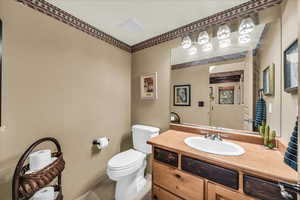 Half bathroom with vanity and toilet