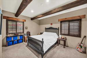 Bedroom featuring carpet, beamed ceiling, and recessed lighting