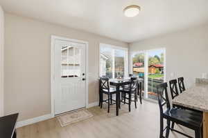 Dining area with light wood-style floors and baseboards