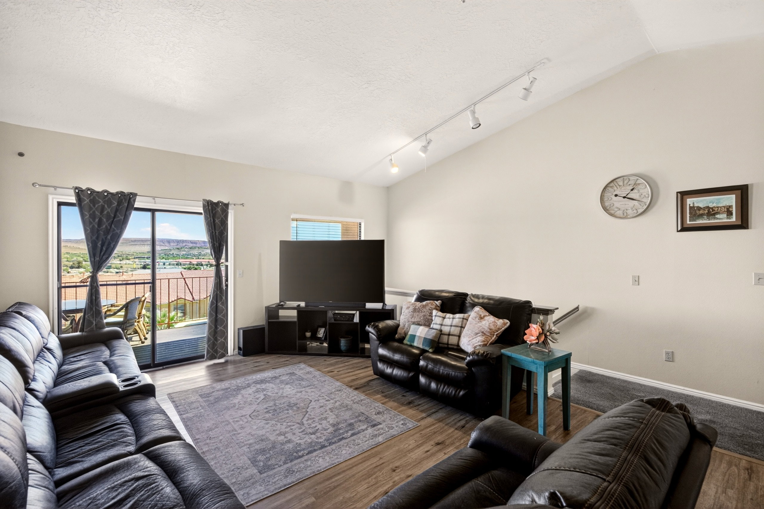 Living area featuring track lighting and wood finished floors