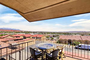 Balcony featuring a residential view and a mountain view