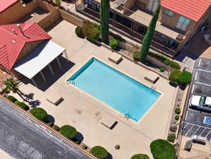 Community pool with a patio