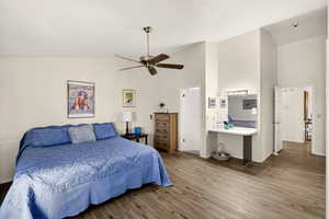 Bedroom with vaulted ceiling, wood finished floors, and ceiling fan