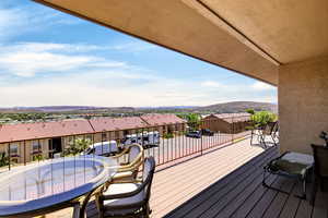 Deck with a residential view and a mountain view