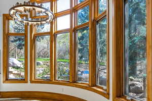 Unfurnished sunroom with a chandelier