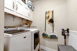 Laundry area featuring cabinet space and washing machine and dryer
