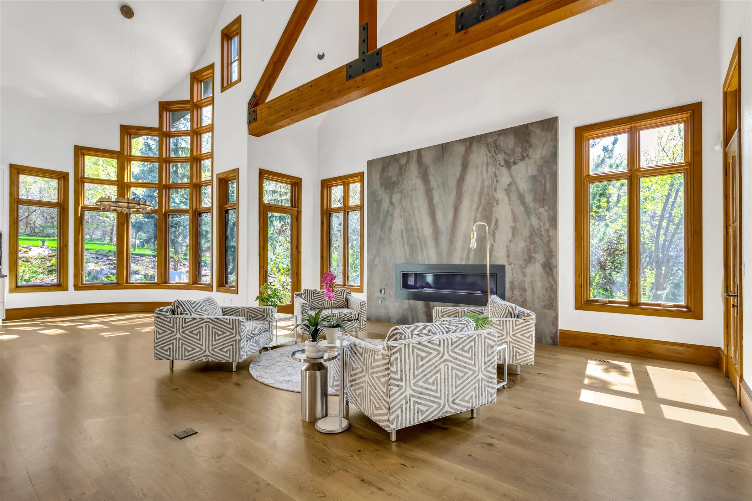 Great room featuring lots of windows and beautiful oak floors.