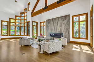 Living area featuring a fireplace, wood finished floors, and vaulted ceiling