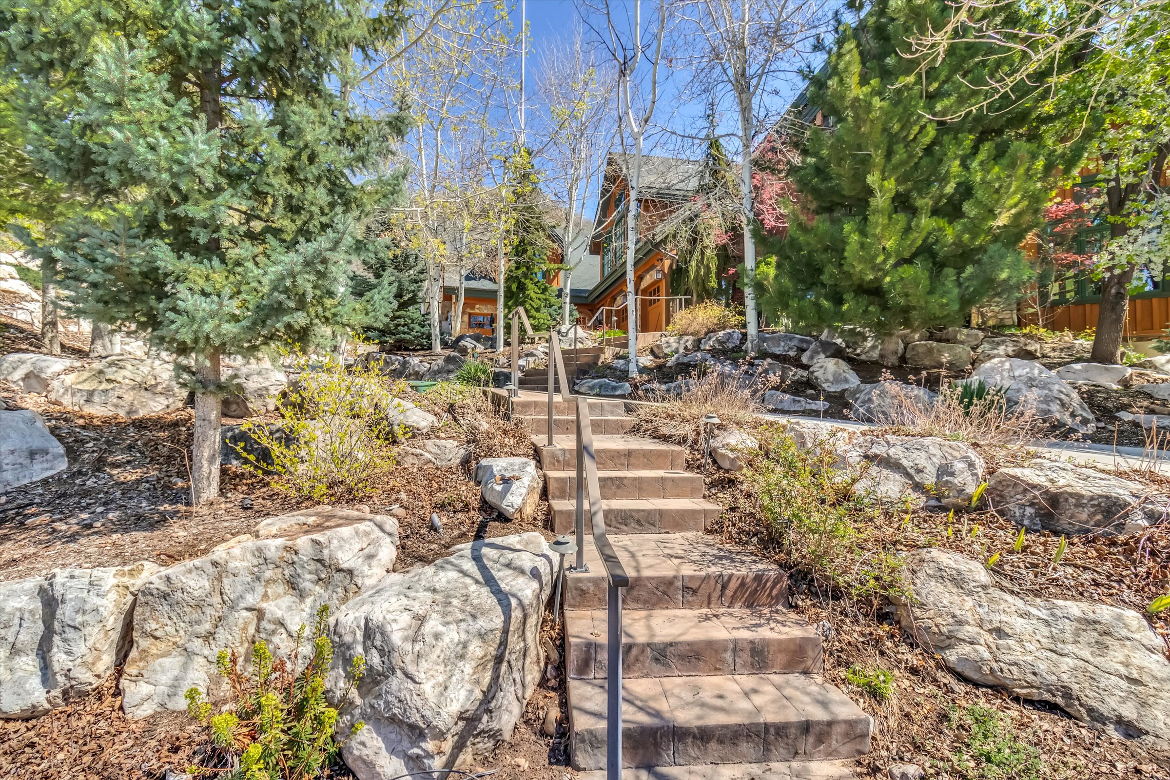 Tiered front yard offers access from street level via heated steps.