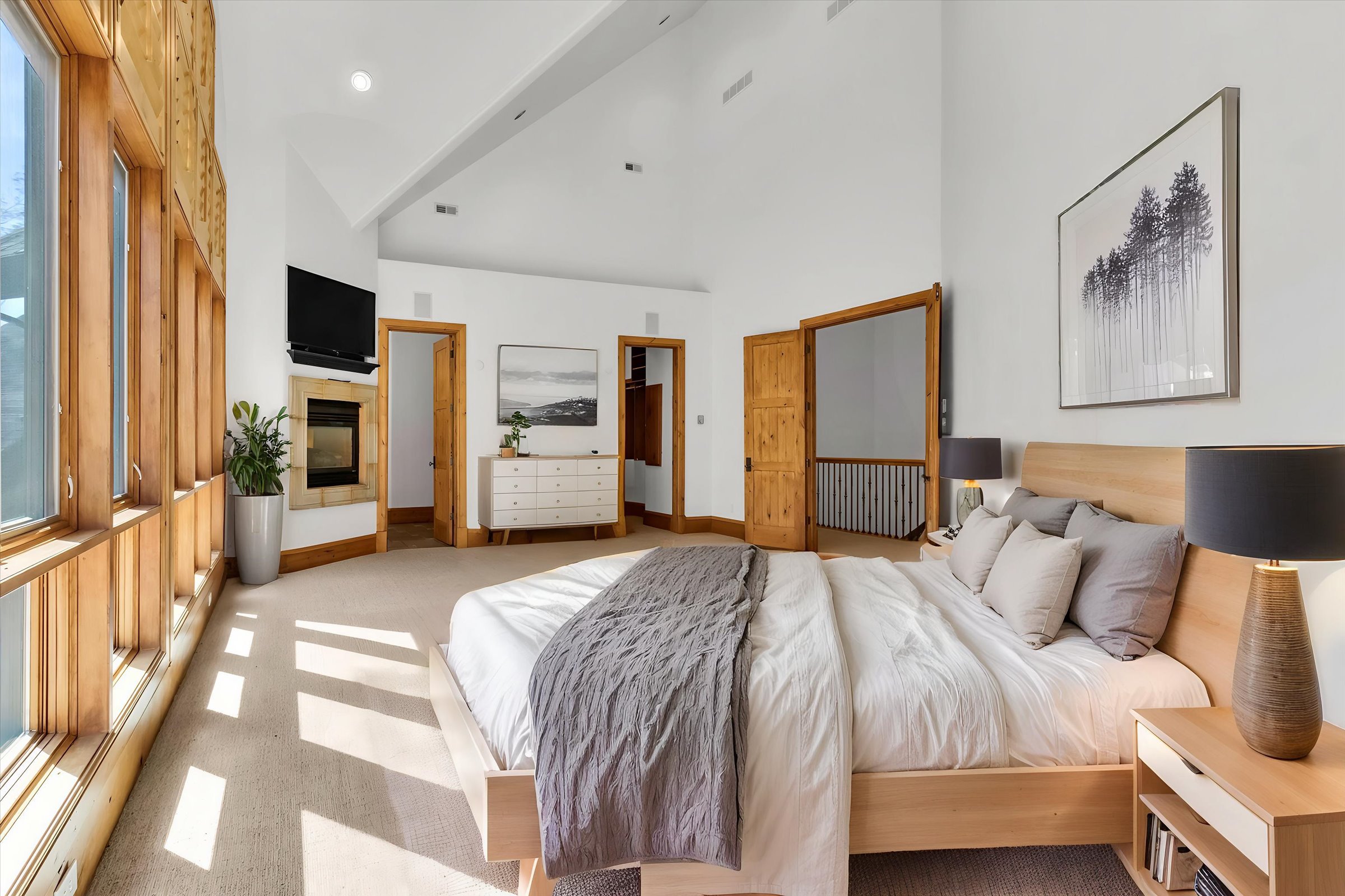 Owner’s suite with tons of natural light, access to private patio and sauna, and dual-sided fireplace. Automatic exterior window shades provide privacy and sun protection.