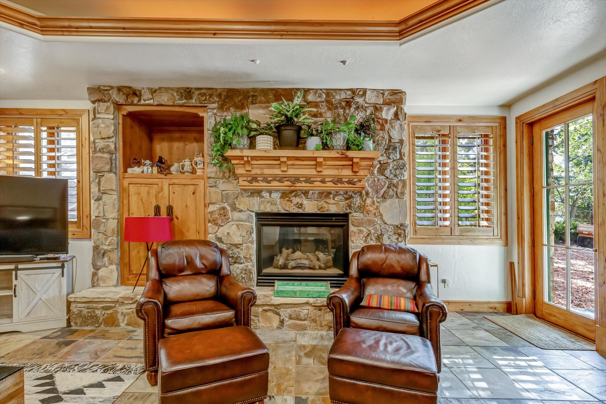 Gorgeous millwork and stonemasonry. Notice the wood clad windows and hardwood plantation shutters!