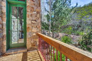 Entrance to property featuring stone siding