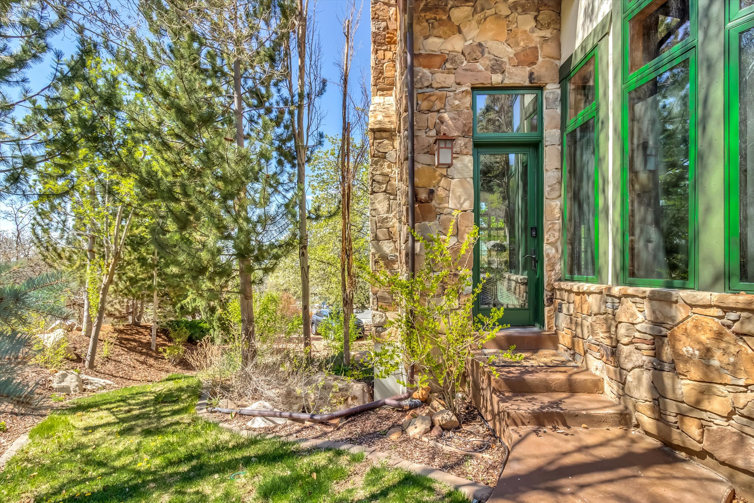 Stone cladding wraps around the entire home, exemplifying the craftsmanship and luxury offered in every facet of this home.