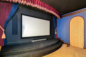 Home theater with carpet floors and ornamental molding