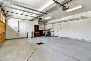 Garage with a garage door opener and refrigerator