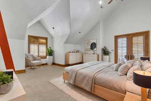 Bedroom featuring light colored carpet, vaulted ceiling, french doors, and ceiling fan. (virtual stanging)
