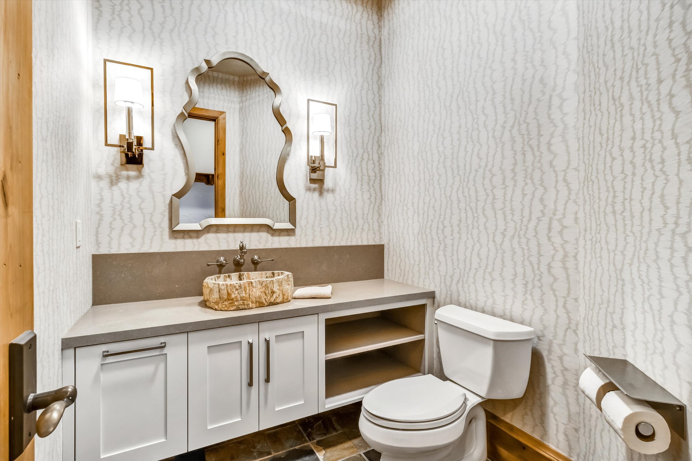Newly updated powder room with custom finishes (the wash basin is polished petrified wood!)
