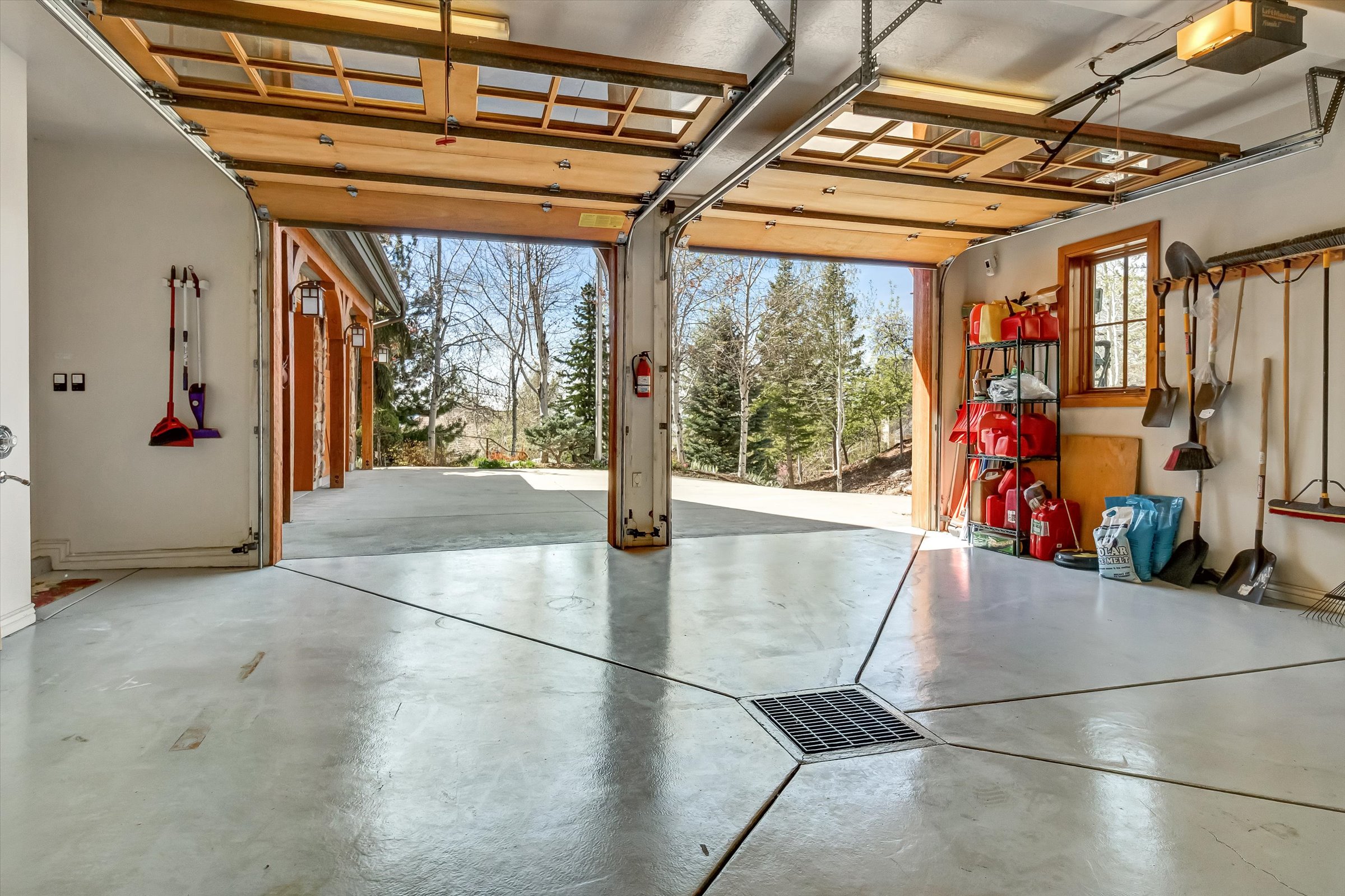 Heated garages feature floor drains, hot water with hose hookup, epoxy floors, and cabinetry.