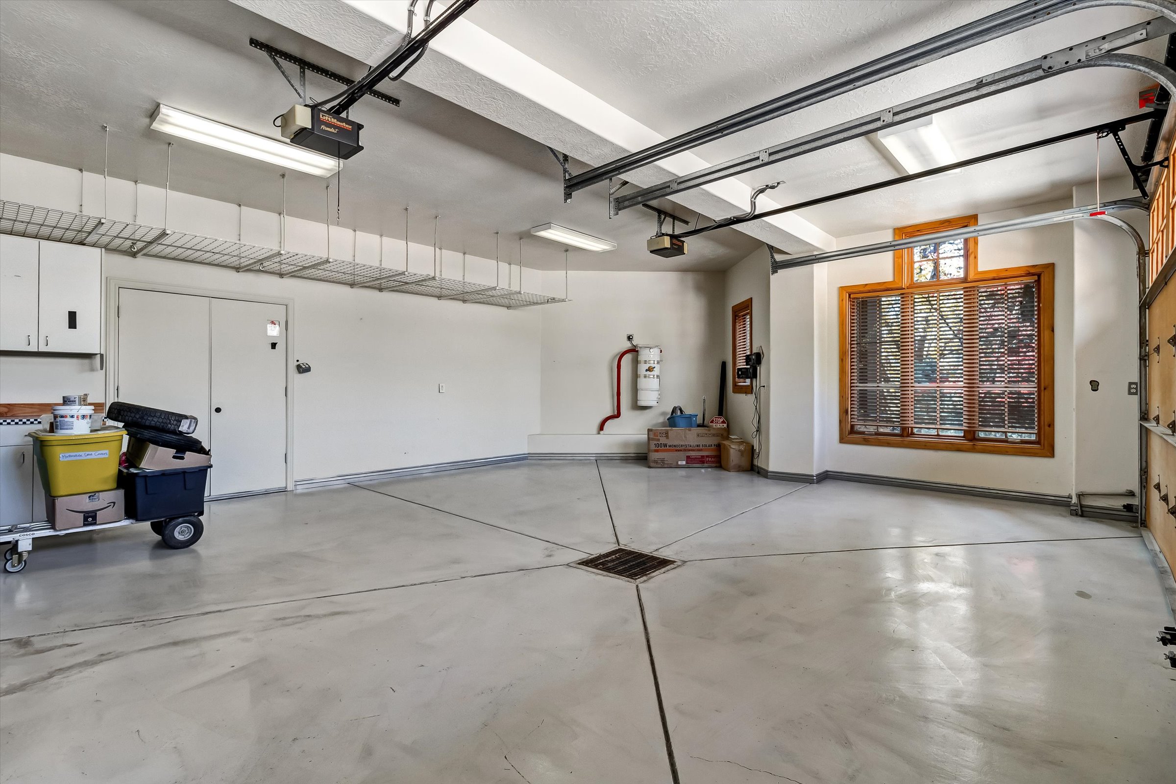 Heated garages feature floor drains, utility sink, epoxy floors, and cabinetry.