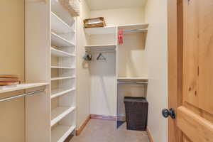 Walk in closet with light carpet