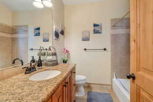 Bathroom with vanity, light tile patterned floors, and shower / bath combination