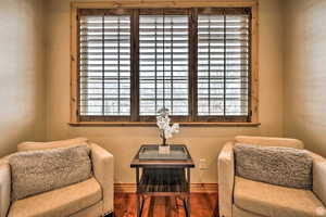 Living area with wood finished floors and baseboards