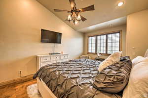 Bedroom featuring lofted ceiling, ceiling fan, wood finished floors, and recessed lighting