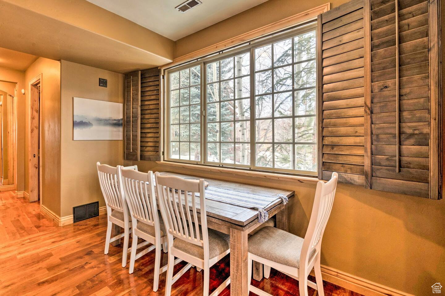 Dining space with plenty of natural light and wood finished floors