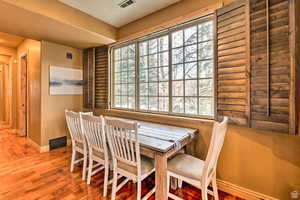 Dining space with plenty of natural light and wood finished floors