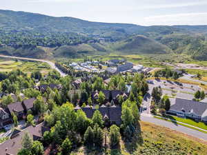 Aerial view of property's location featuring nearby suburban area and mountains