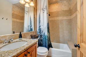 Full bath featuring vanity and shower / bathtub combination with curtain